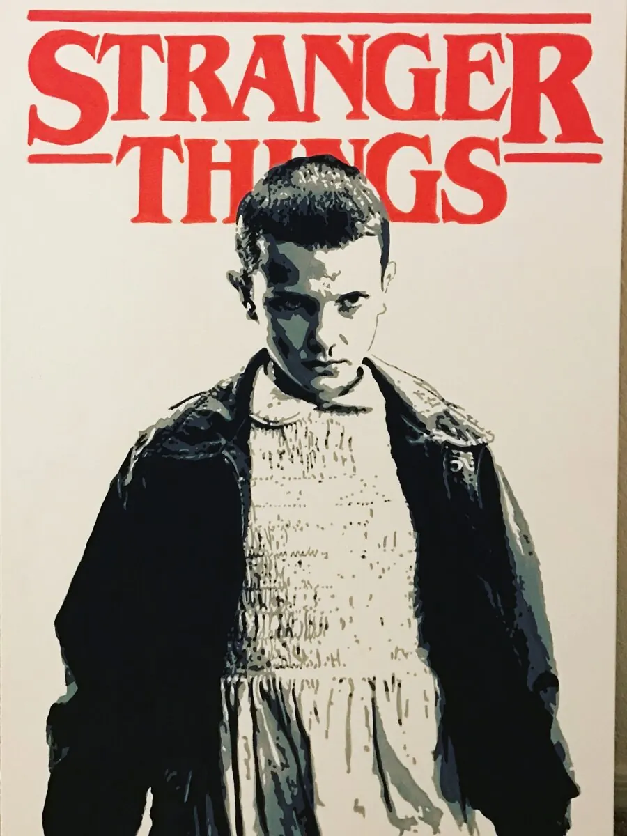 Acrylic painting of Eleven from Stranger Things under the show title in red